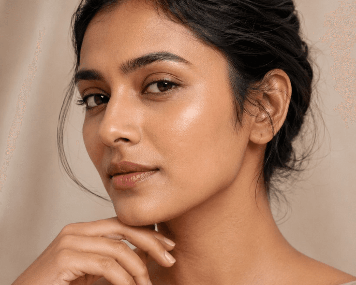 Close detail of soft, even skin texture in warm editorial light